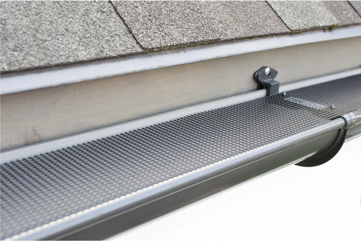 Micro-mesh gutter guard blocking conifer needles